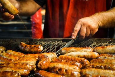 Man preparing sausage on grill