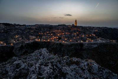 High angle shot of illuminated buildings in city at sunset