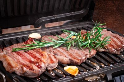 High angle view of meat on barbecue grill