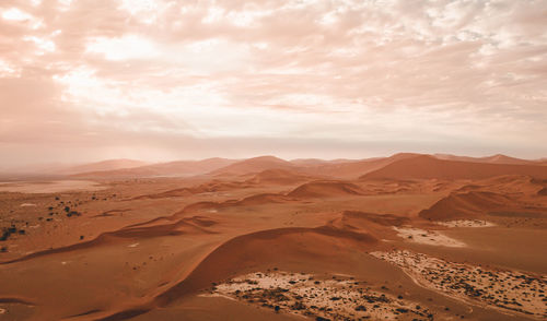 Scenic view of landscape against cloudy sky