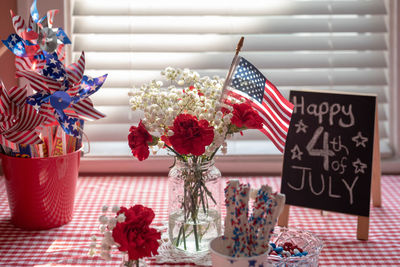 Close-up of red flower vase on table