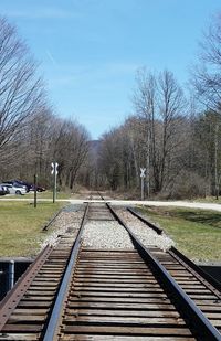 Railroad track amidst bare trees