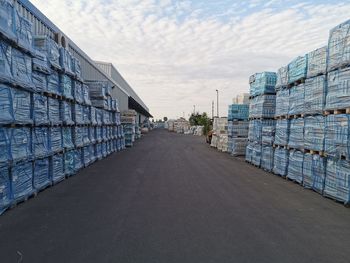 Stack of road by building against sky