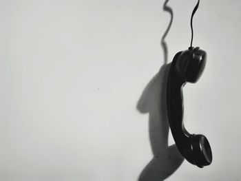 Close-up of silhouette man hanging against wall