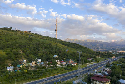 High angle view of road amidst trees against sky