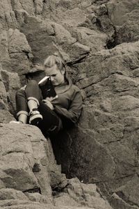 Young woman sitting on sand at beach