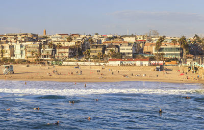 View of beach against buildings in city