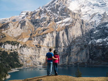 Rear view of people walking on mountain
