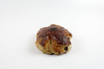 Close-up of bread over white background