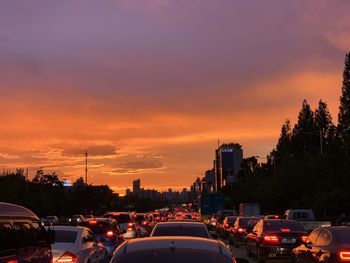 Traffic on street at sunset