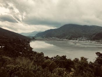 Scenic view of lake and mountains against sky