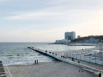 People on beach against sky