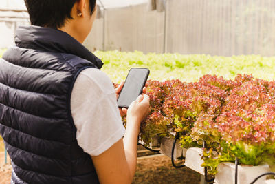 Side view of woman using mobile phone