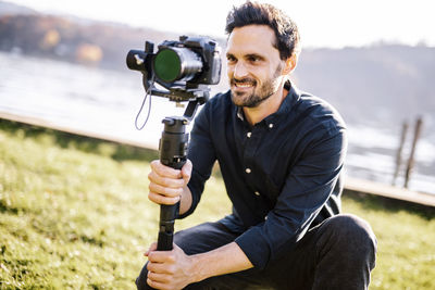 Portrait of young man photographing