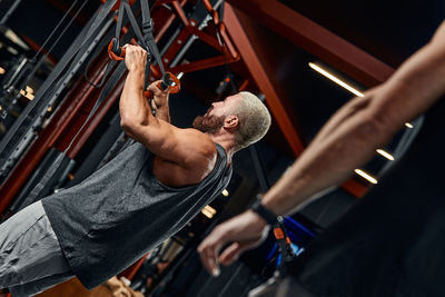 Muscular man exercising at gym