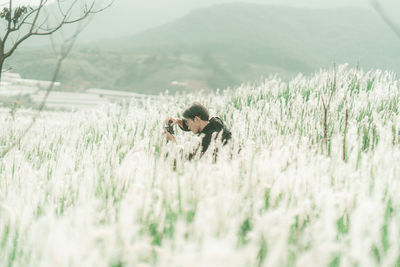 Portrait of man standing in the middle of white reeds