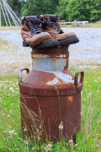 Close-up of rusty metal on field