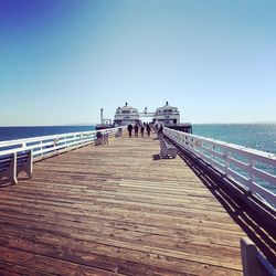 Pier over sea against clear sky