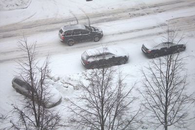 High angle view of snow covered car on road
