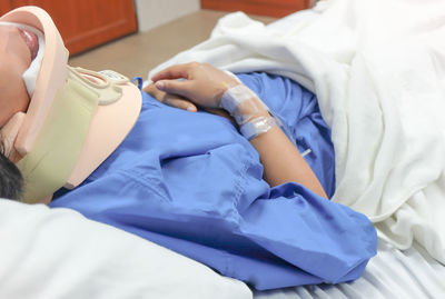 Midsection of woman lying on bed