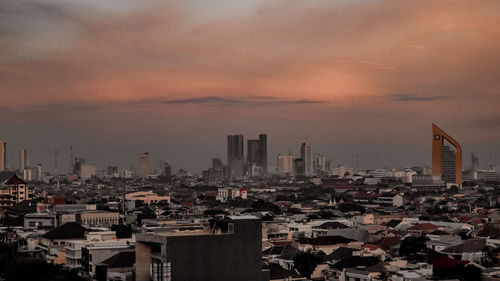 High angle view of city buildings during sunset