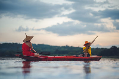 Red boat in lake against sky