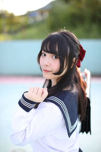 Portrait of young woman standing outdoors