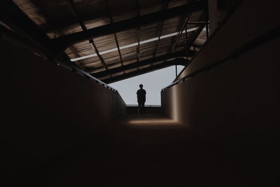 Silhouette man standing in corridor