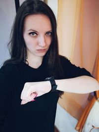 Portrait of beautiful woman standing at home