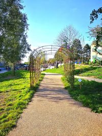 Footpath in park against sky