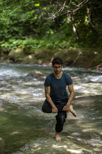 Side view of man standing in lake