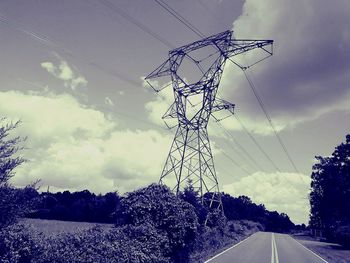 Low angle view of electricity pylon against sky