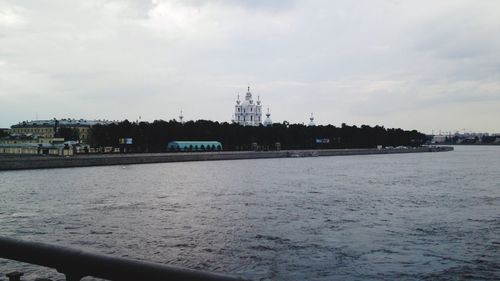 Scenic view of river against cloudy sky