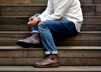 Low section of man sitting on bench
