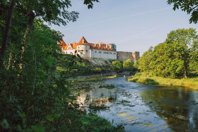 River amidst buildings against sky