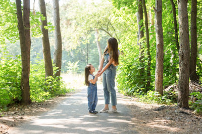 Woman with daughter in forest