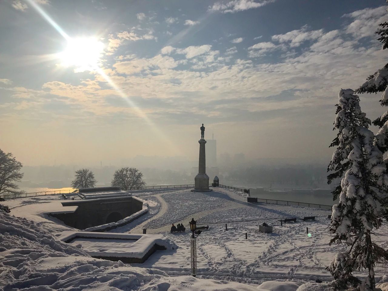 PANORAMIC VIEW OF SNOW COVERED LANDSCAPE AGAINST SKY DURING SUNSET