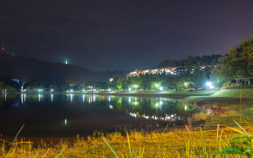 Scenic view of lake against sky at night