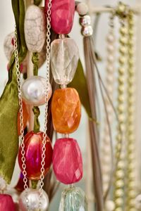 Close-up of a colourful necklace and silver chain