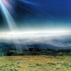 Aerial view of landscape against cloudy sky