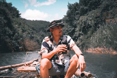 Young man looking at river