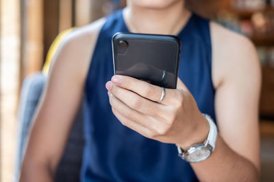 Midsection of woman using mobile phone