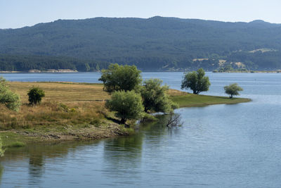 Scenic view of lake and mountains against sky