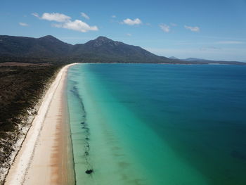 Scenic view of beach against blue sky