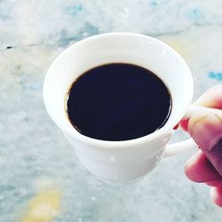 Close-up of hand holding black coffee