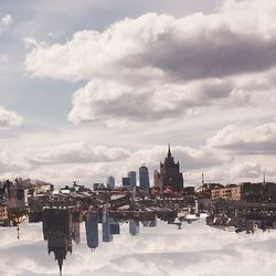Cityscape against cloudy sky