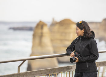 Woman admiring the 12 apostles sea stacks in the south of australia