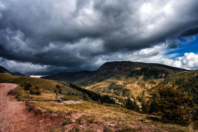 Scenic view of mountains against cloudy sky