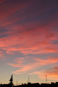 Low angle view of silhouette buildings against sky during sunset