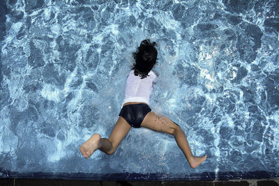 High angle view of woman diving in swimming pool